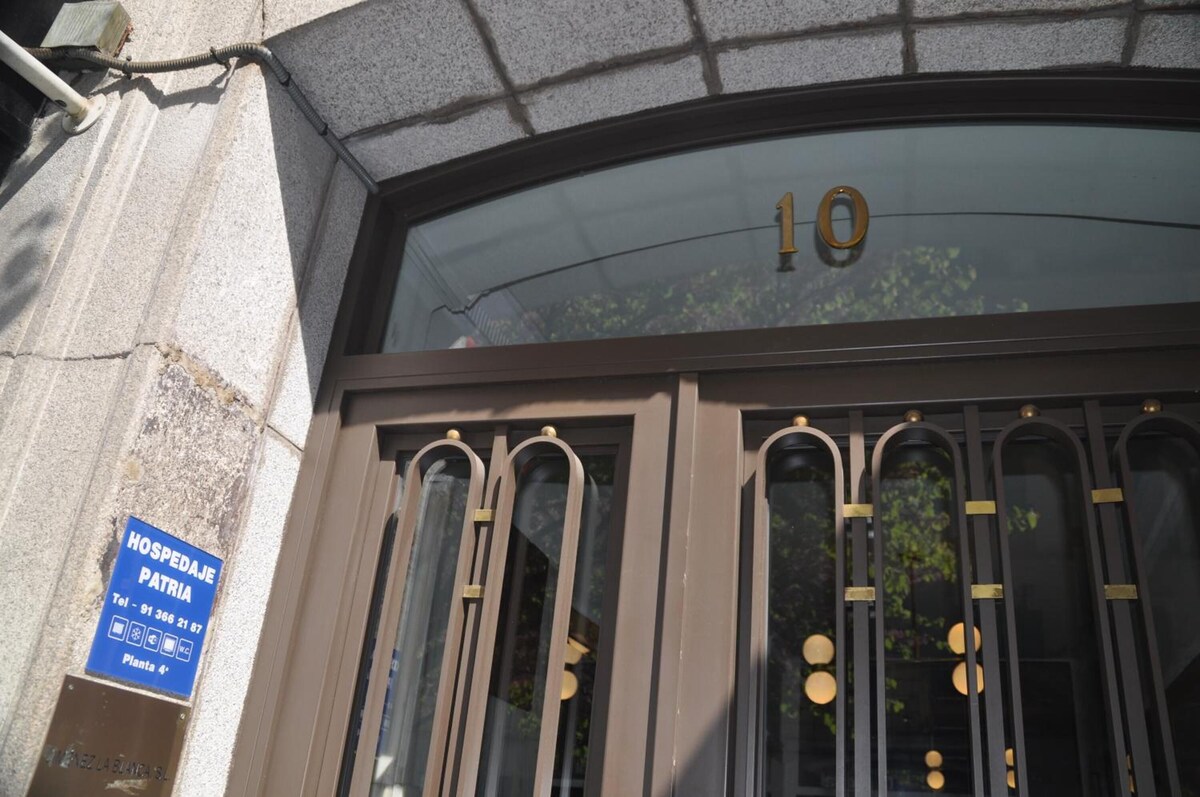 Entrada de Calle Mayor, 10, con la placa azul de Hospedaje Patria junto al portal
